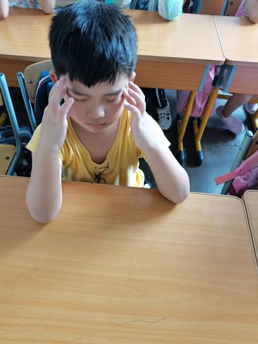小朋友课间摸金属课桌被静电打后的表情特写