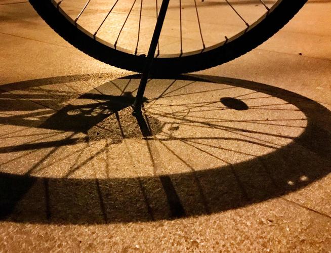 夜晚小区路灯下自行车轮胎影子