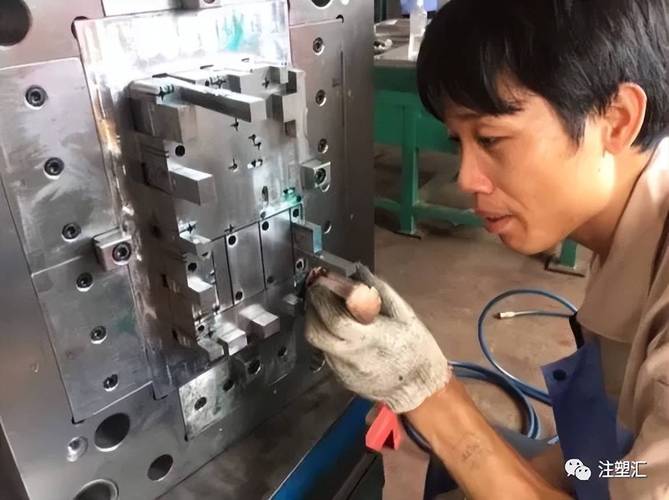 注塑车间操作员精细擦拭模具