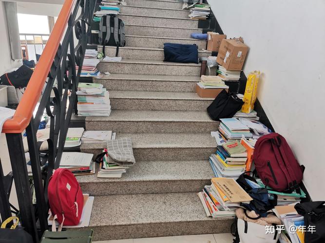大学早八学生抱着课本赶教学楼走廊的实拍场景