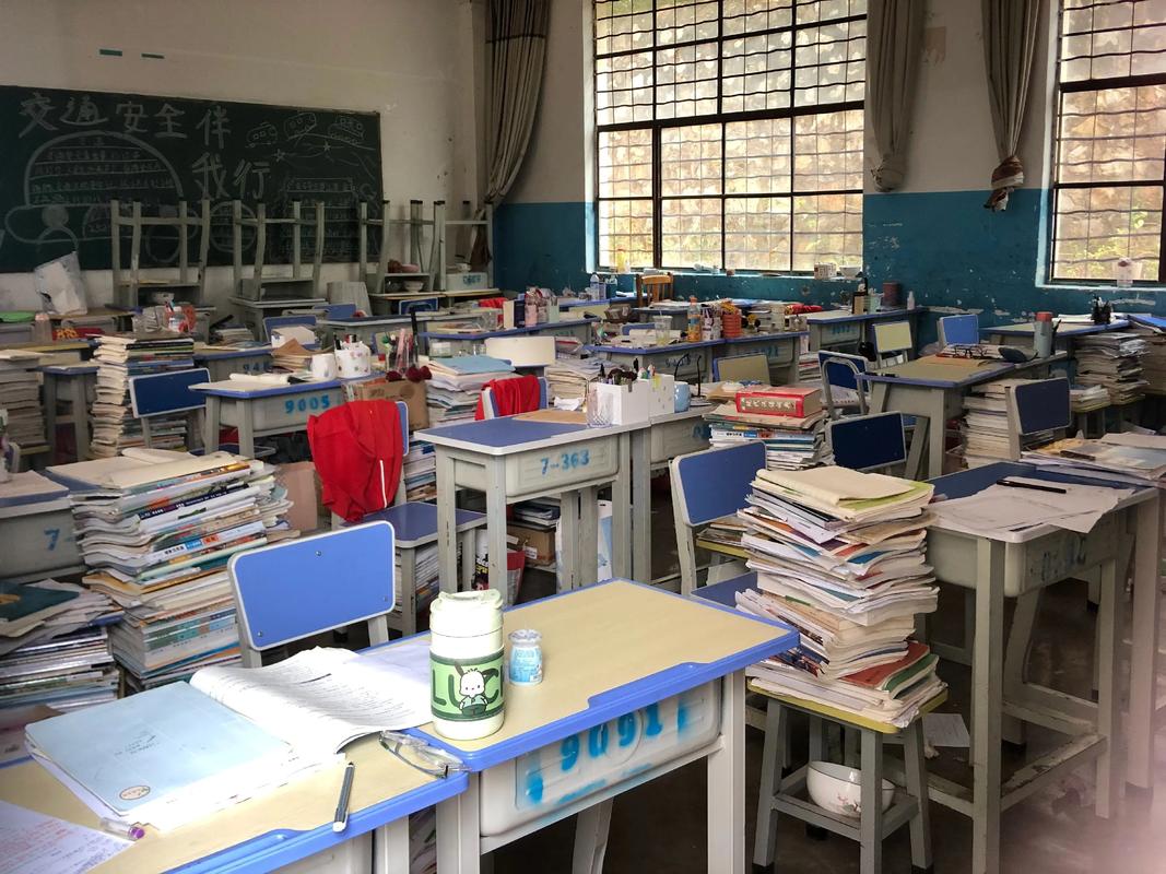 高中教室课桌上摊开的待交练习册