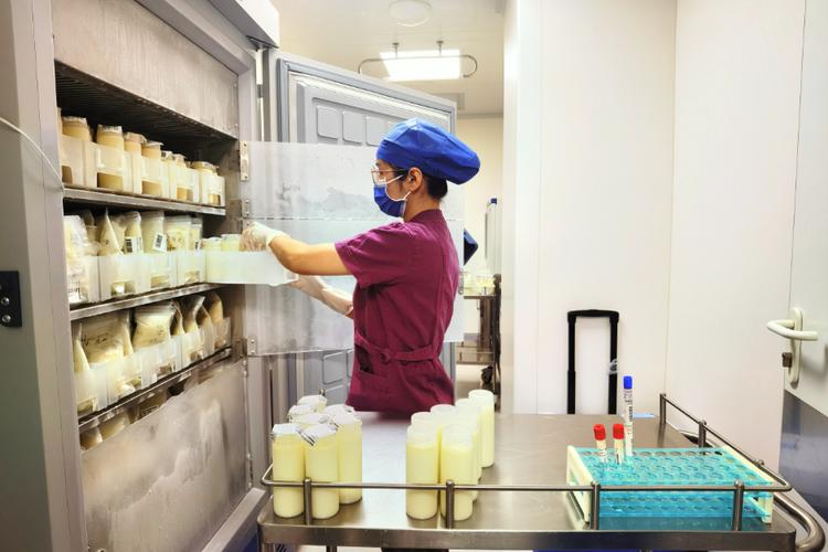 母乳捐赠库工作人员将奶瓶放入巴氏消毒设备