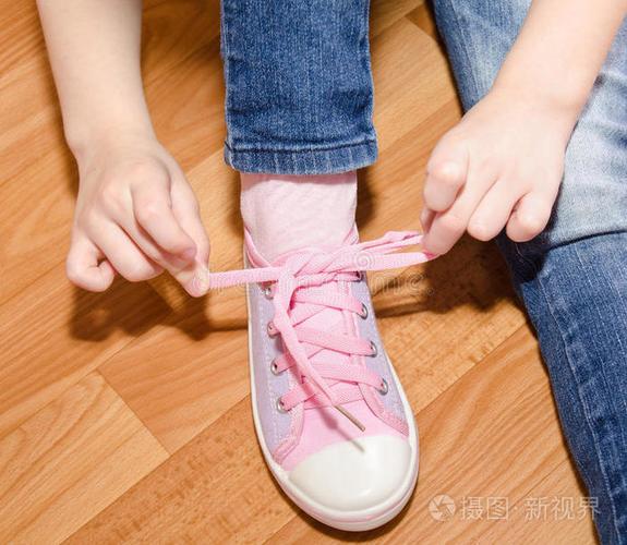 一年级儿童自己系鞋带玄关场景图