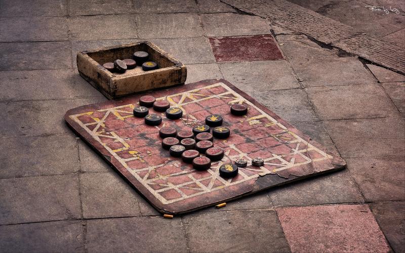 旧木质棋盘上散落的象棋棋子