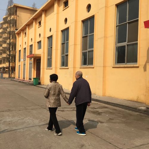 老工业厂区家属院门口祖孙同行图