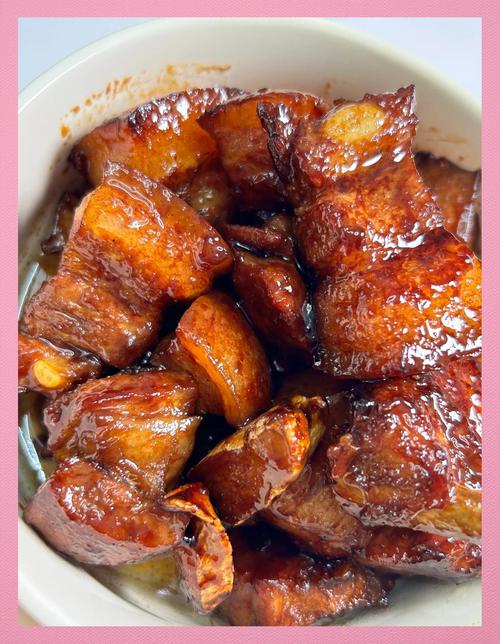 家常红烧肉炖煮过程特写，肉块软烂油润