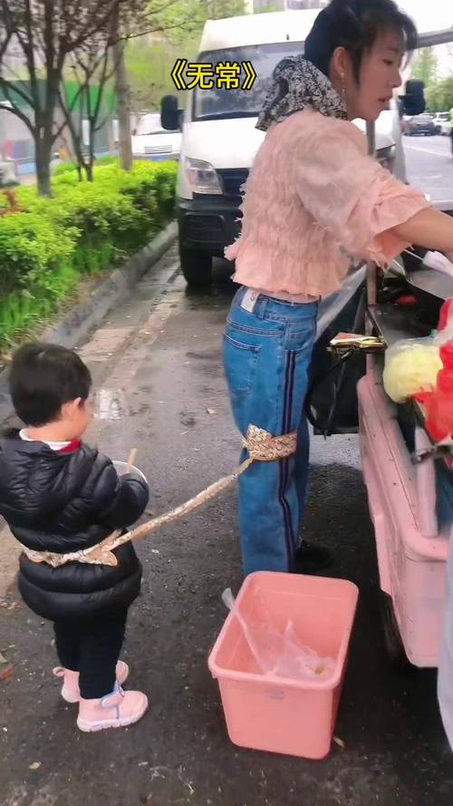 妈妈用防走失绳带着幼儿逛集市