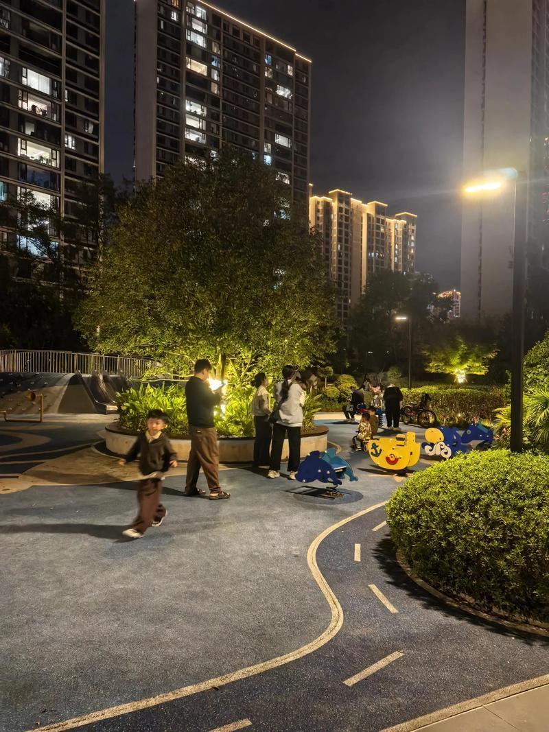 城市年轻父母加班晚归路过小区游乐场场景