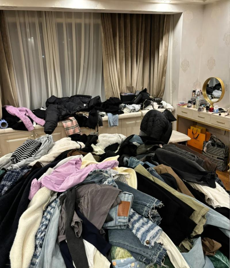 堆满衣服杂物的出租屋卧室场景