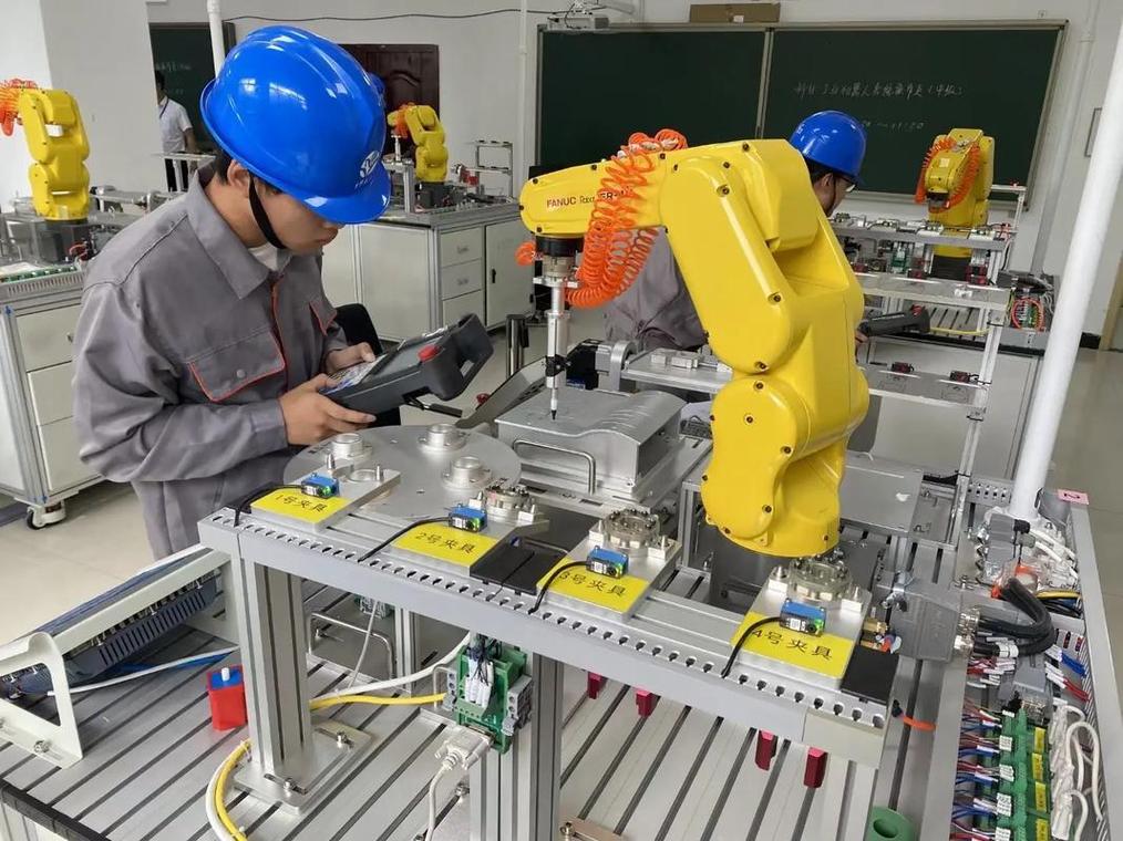 工厂车间里自动化设备旁年轻工程师操作