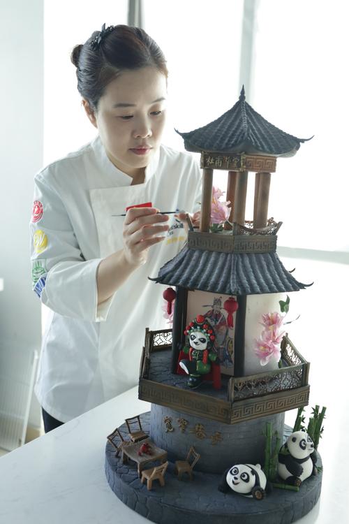 糕点师正在给蛋糕覆盖翻糖皮