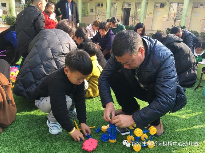 家长陪孩子拼工业机械模型亲子互动照片
