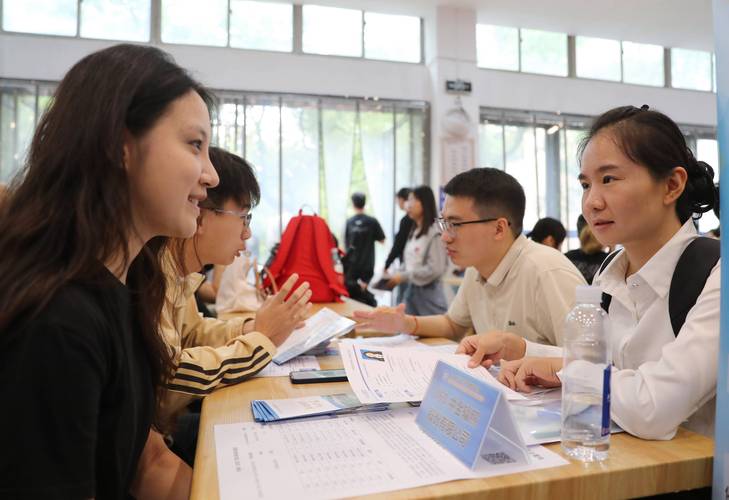 招聘会现场大学生求职者简历交流场景图