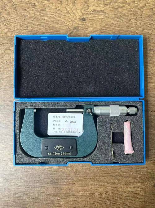 车间老师傅用千分表检测精密磨削工件