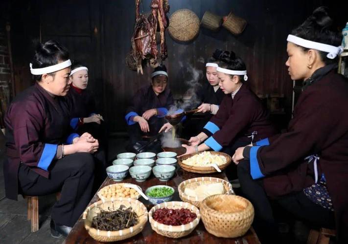 贵州黔东南苗寨儿童踩着竹凳帮长辈搅油茶的日常场景