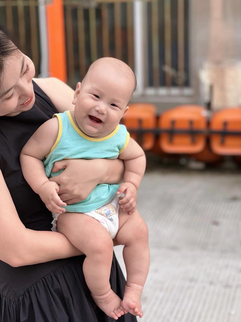 新手妈妈沾了屎尿的衣服抱娃笑照片