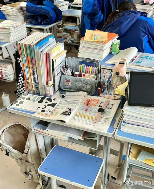 学生在图书馆堆满书的书桌前抓狂学习