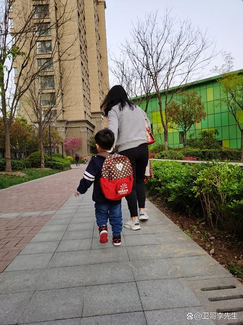 清晨校门口妈妈蹲下鼓励孩子的背影