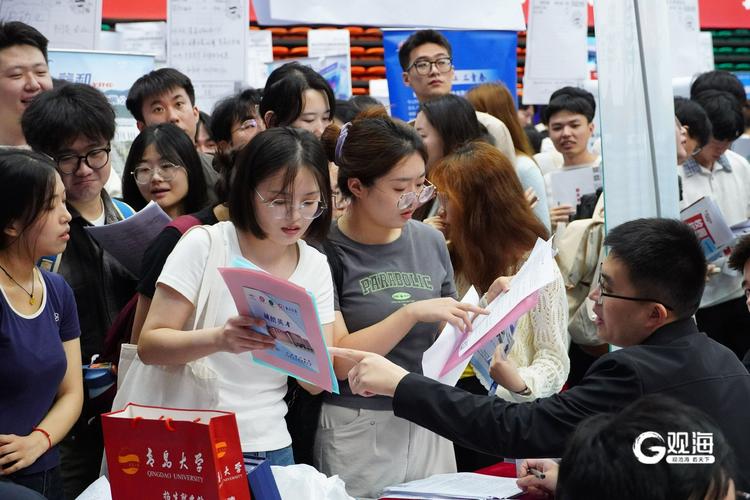 大学毕业生在招聘会上拥挤投简历的场景