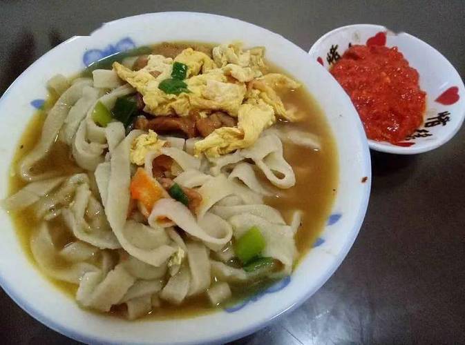 柴铁锅盛出撒青蒜碎的热煮东至豆丝