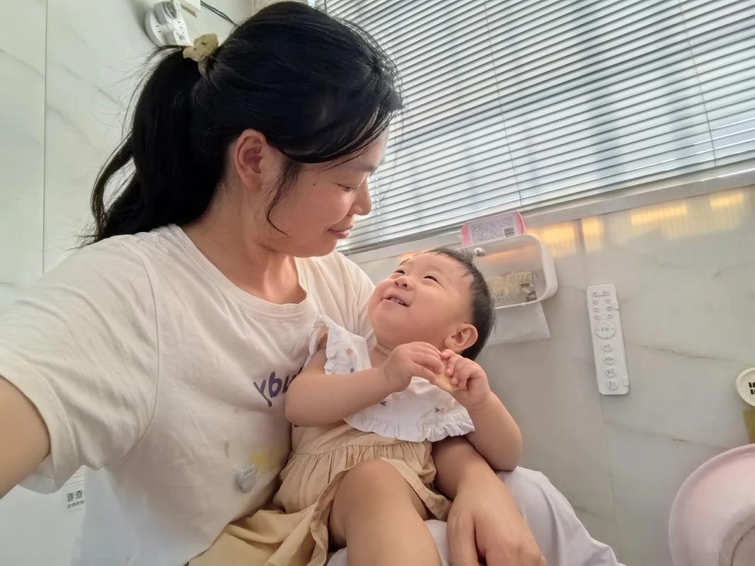 妈妈疲惫却温柔地抱着哭泣的婴儿,房间微光