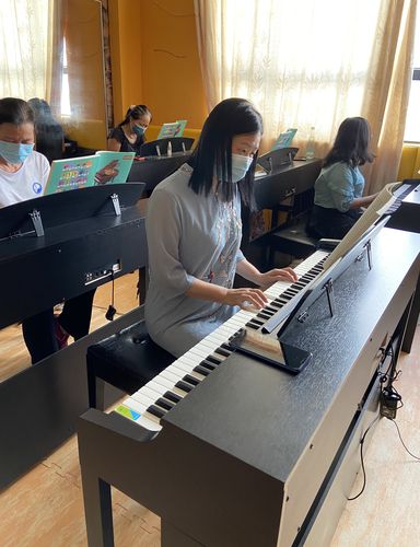 老小区单元楼楼下小孩练钢琴生活场景