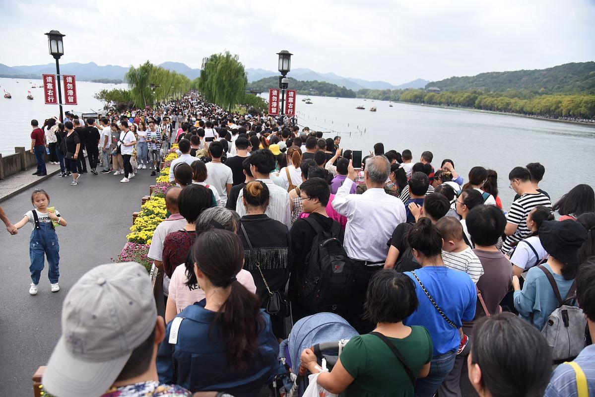 西湖断桥游客扎堆举手机拍照现场
