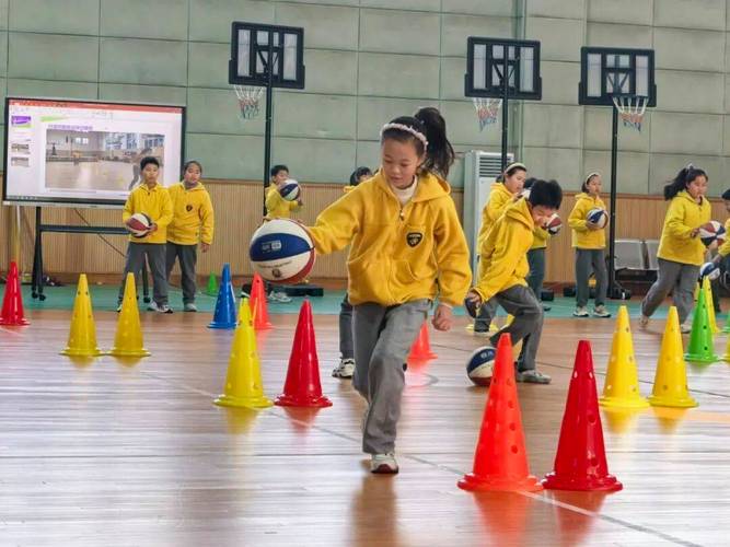 中小学体育课堂行进间绕桶运球练习场景