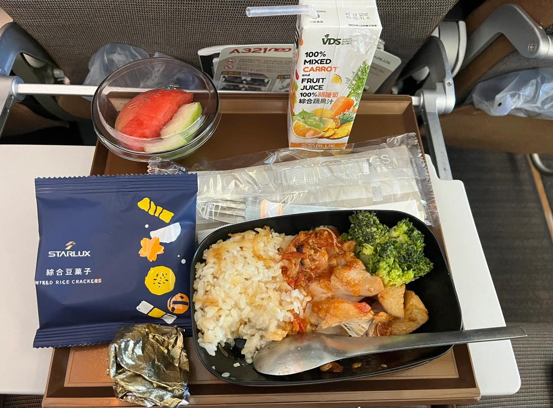 人在飞机上吃简餐 返程旅途疲惫