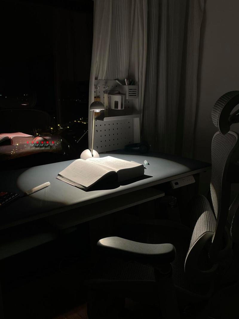 学生疲劳趴在书桌前台灯深夜学习场景图