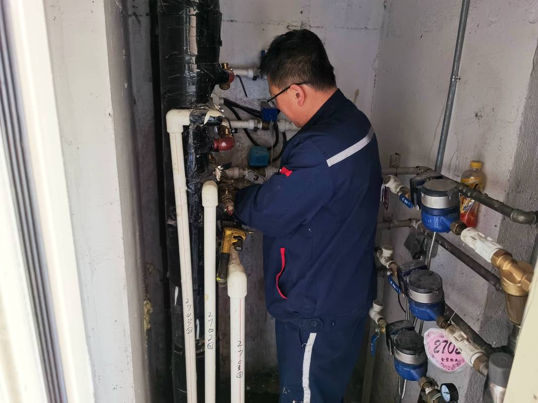 北方老旧小区改造工人调试工业供暖设备实景