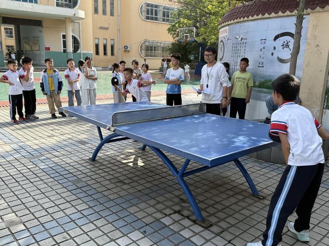 小学操场乒乓球台边落单男孩