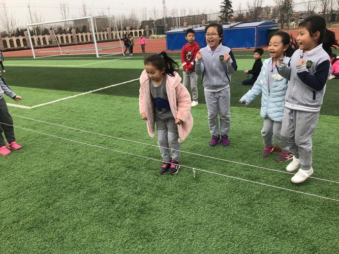 小学操场沙坑边跳绳测查场景