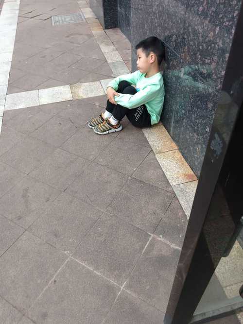 小区花坛边坐地哭的受伤小男孩