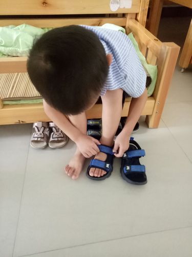 2岁宝宝蹲在玄关反穿鞋的生活化实拍