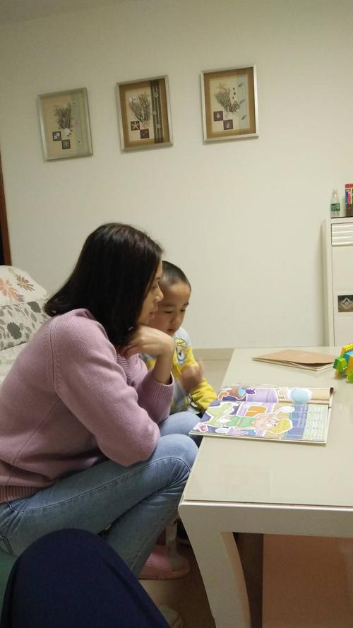 工业一线父母陪孩子在出租屋读绘本场景图