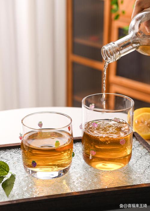 居家餐桌上放着盛有温白开的透明玻璃杯