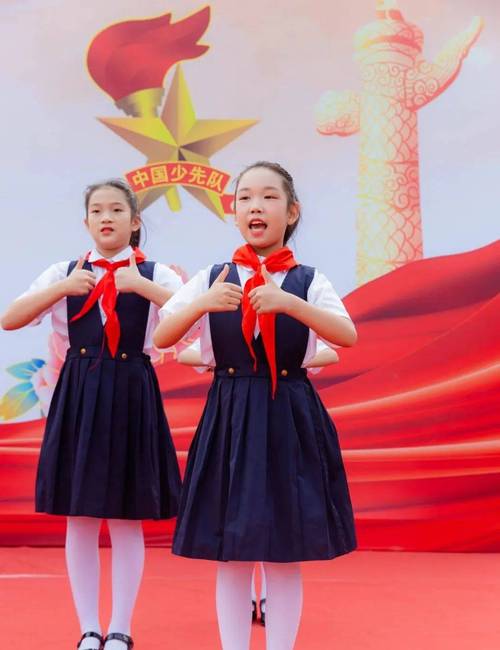 小学一年级新生学唱队歌戴红领巾场景