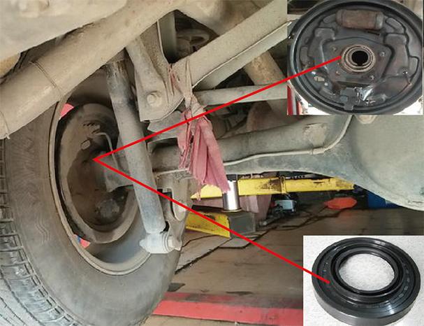 汽修师傅架起后驱车辆检查后桥差速器漏油现场