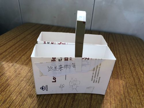 小学教室角落学生用快递盒自制的失物招领筐