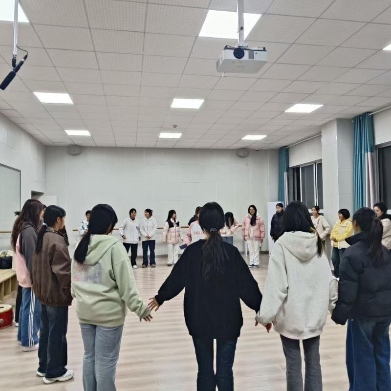 学生们在课堂上围坐进行破冰游戏的场景