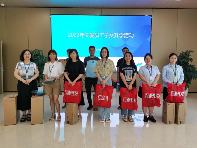 汽车零配件工厂给员工子女发开学大礼包合影