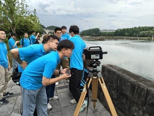 学生团队在古桥下测量数据并记录
