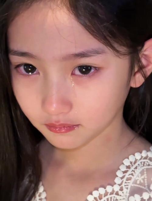校门口摔疼后憋泪的小学女生