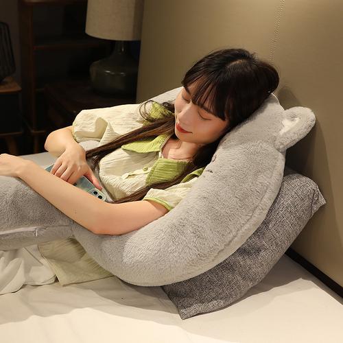 女生靠在卧室抱枕上放松发呆场景图