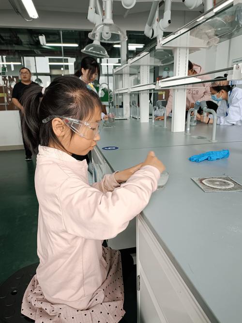 女工程师给小学生讲解工业机械臂操作原理